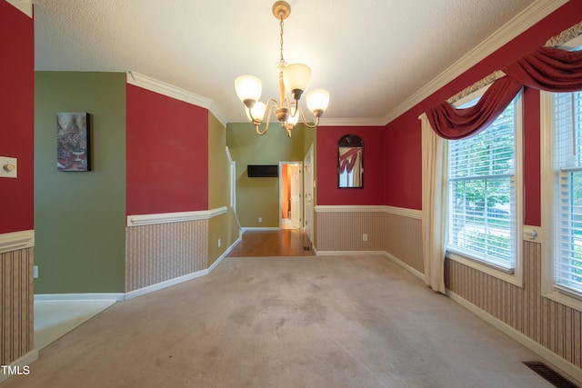 203 Halls Mill Dr, Cary, NC 27519 - unfurnished dining area featuring a chandelier, carpet flooring, wainscoting, and ornamental molding