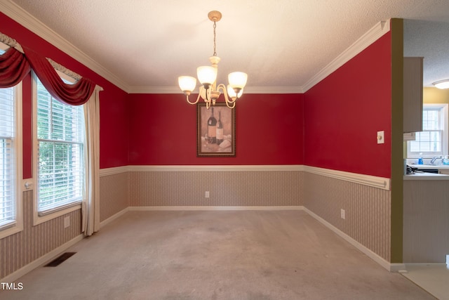 203 Halls Mill Dr, Cary, NC 27519 - spare room featuring a chandelier, wainscoting, crown molding, carpet floors, and a textured ceiling