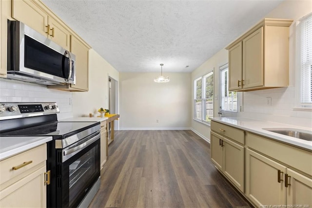 6466 Applewhite Rd, Fayetteville, NC 28304 - kitchen with appliances with stainless steel finishes, dark wood-style floors, light countertops, decorative backsplash, and a textured ceiling