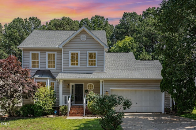 8512 Erinsbrook Dr, Raleigh, NC 27617 - traditional home featuring an attached garage, roof with shingles, driveway, and covered porch
