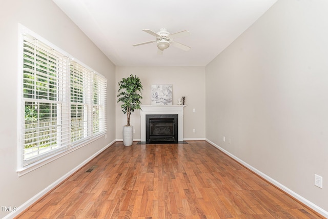 8512 Erinsbrook Dr, Raleigh, NC 27617 - unfurnished living room featuring ceiling fan, light wood-style flooring, a fireplace, and baseboards
