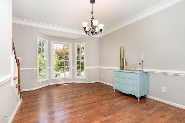 8512 Erinsbrook Dr, Raleigh, NC 27617 - unfurnished room featuring a chandelier, ornamental molding, wood finished floors, and baseboards
