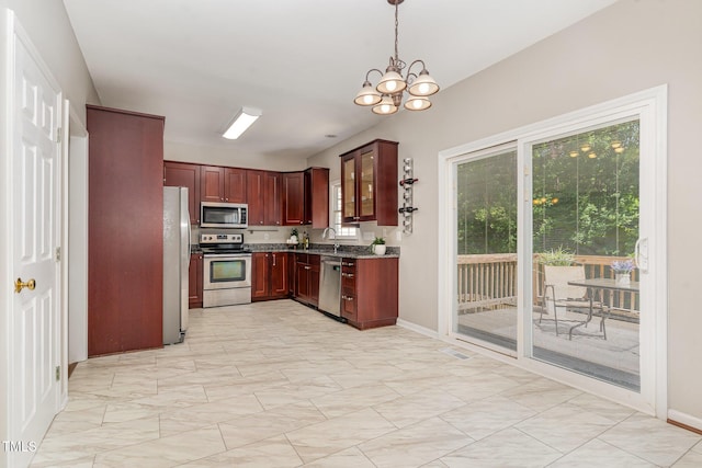 8512 Erinsbrook Dr, Raleigh, NC 27617 - kitchen with appliances with stainless steel finishes, a sink, a chandelier, baseboards, and hanging light fixtures
