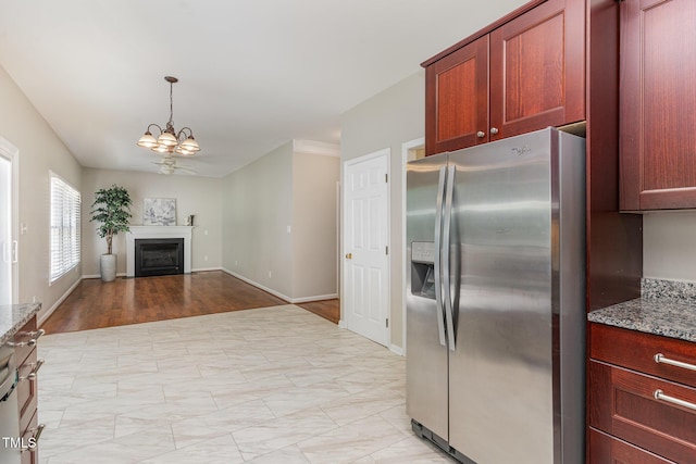 8512 Erinsbrook Dr, Raleigh, NC 27617 - kitchen featuring stainless steel fridge, a chandelier, light stone counters, a fireplace, and open floor plan