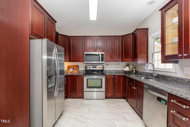 8512 Erinsbrook Dr, Raleigh, NC 27617 - kitchen featuring stainless steel appliances, a sink, light marble finish floors, and dark stone counters