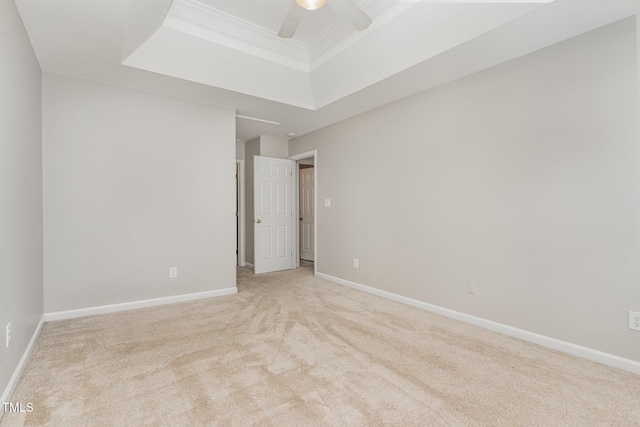 8512 Erinsbrook Dr, Raleigh, NC 27617 - empty room featuring a tray ceiling, attic access, light carpet, a ceiling fan, and baseboards