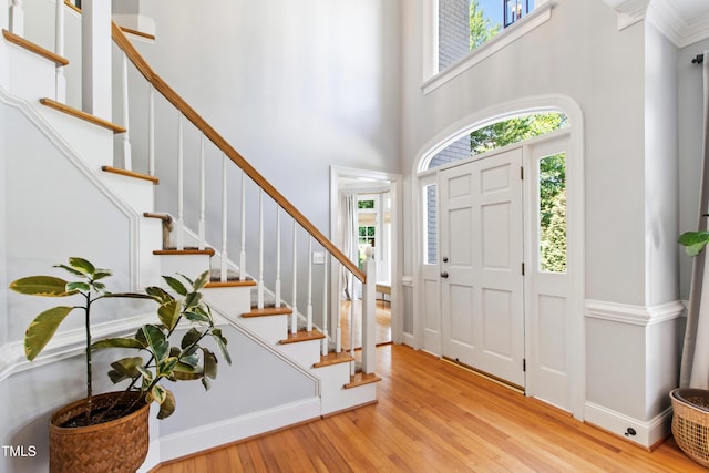3304 Buck Run Trl, Wake Forest, NC 27587 - entrance foyer with light wood-style flooring, a towering ceiling, and stairs