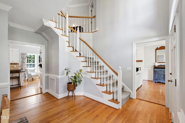 3304 Buck Run Trl, Wake Forest, NC 27587 - staircase with wood finished floors, crown molding, and a towering ceiling