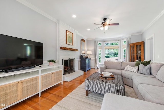 3304 Buck Run Trl, Wake Forest, NC 27587 - living area with ceiling fan, crown molding, a fireplace, wood finished floors, and recessed lighting