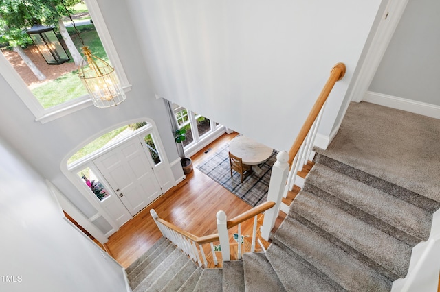 3304 Buck Run Trl, Wake Forest, NC 27587 - entryway with plenty of natural light, stairway, a chandelier, wood finished floors, and a high ceiling