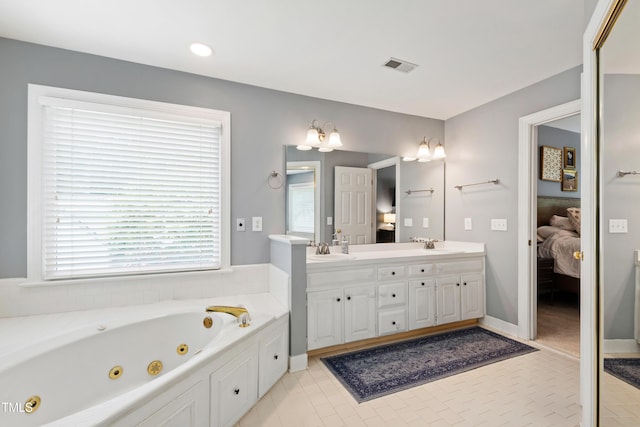 3304 Buck Run Trl, Wake Forest, NC 27587 - ensuite bathroom featuring double vanity, a tub with jets, tile patterned floors, and recessed lighting