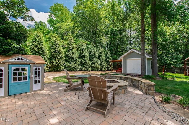 3304 Buck Run Trl, Wake Forest, NC 27587 - view of patio / terrace with an outdoor fire pit, a detached garage, outdoor dining area, and a storage unit