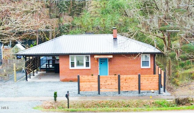 2907 University Dr, Durham, NC 27707 - view of front of home featuring brick siding, a chimney, and a metal roof