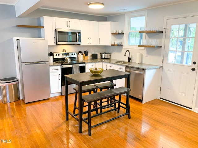 2907 University Dr, Durham, NC 27707 - kitchen featuring stainless steel appliances, open shelves, white cabinetry, and crown molding