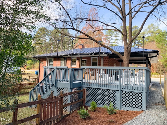 2907 University Dr, Durham, NC 27707 - back of house featuring brick siding, stairway, a chimney, and a metal roof