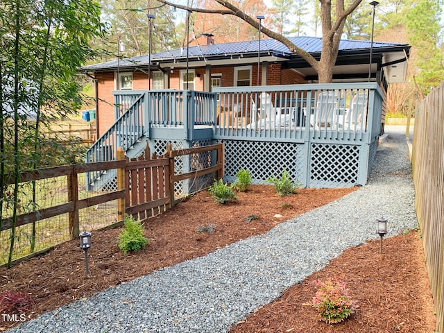 2907 University Dr, Durham, NC 27707 - rear view of property featuring brick siding, a metal roof, covered porch, and stairway