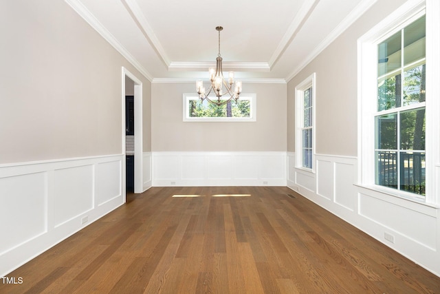 59 Cardinal Dr, Whispering Pines, NC 28327 - unfurnished dining area featuring a raised ceiling, a chandelier, dark wood-style floors, crown molding, and a wainscoted wall