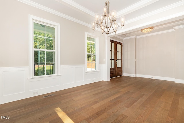 59 Cardinal Dr, Whispering Pines, NC 28327 - unfurnished dining area featuring a chandelier, wood finished floors, a wainscoted wall, crown molding, and a decorative wall