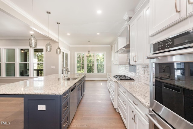 59 Cardinal Dr, Whispering Pines, NC 28327 - kitchen featuring a sink, stainless steel appliances, white cabinets, light wood-type flooring, and tasteful backsplash