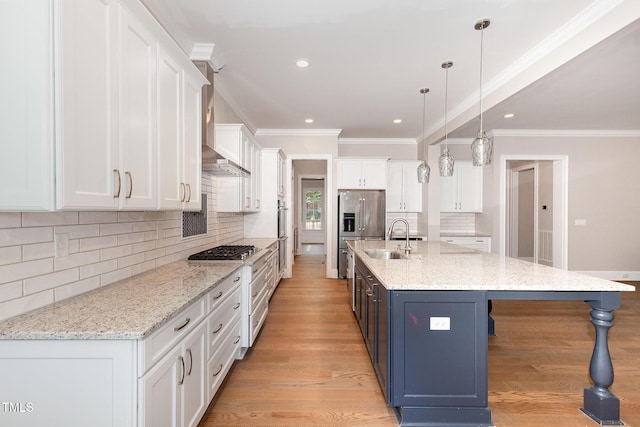 59 Cardinal Dr, Whispering Pines, NC 28327 - kitchen featuring a sink, white cabinetry, a breakfast bar, stainless steel appliances, and tasteful backsplash