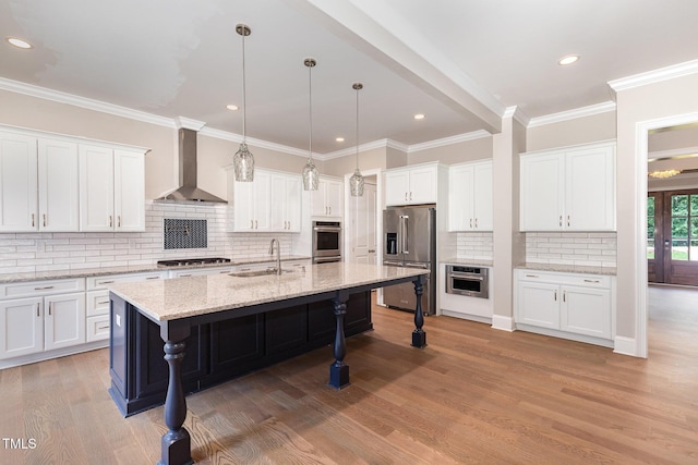 59 Cardinal Dr, Whispering Pines, NC 28327 - kitchen with stainless steel appliances, wall chimney exhaust hood, a sink, a kitchen breakfast bar, and white cabinetry