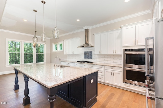 59 Cardinal Dr, Whispering Pines, NC 28327 - kitchen featuring a sink, appliances with stainless steel finishes, wall chimney exhaust hood, white cabinetry, and healthy amount of natural light
