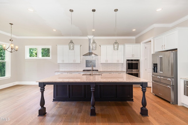 59 Cardinal Dr, Whispering Pines, NC 28327 - kitchen with appliances with stainless steel finishes, wall chimney exhaust hood, a breakfast bar area, white cabinetry, and ornamental molding