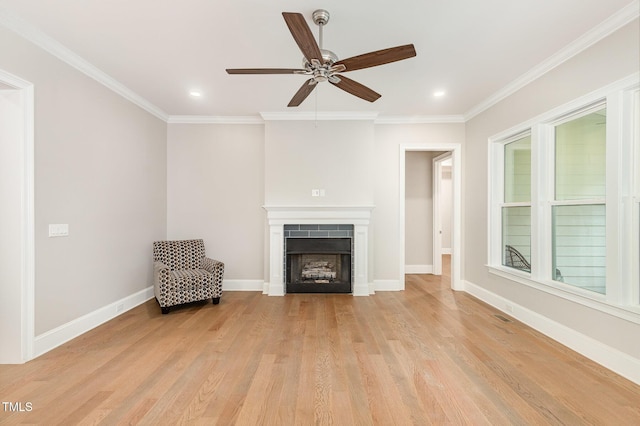 59 Cardinal Dr, Whispering Pines, NC 28327 - unfurnished living room with light wood finished floors, a ceiling fan, a fireplace, crown molding, and baseboards