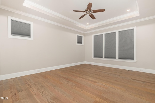 59 Cardinal Dr, Whispering Pines, NC 28327 - empty room featuring a raised ceiling, a ceiling fan, wood finished floors, ornamental molding, and baseboards