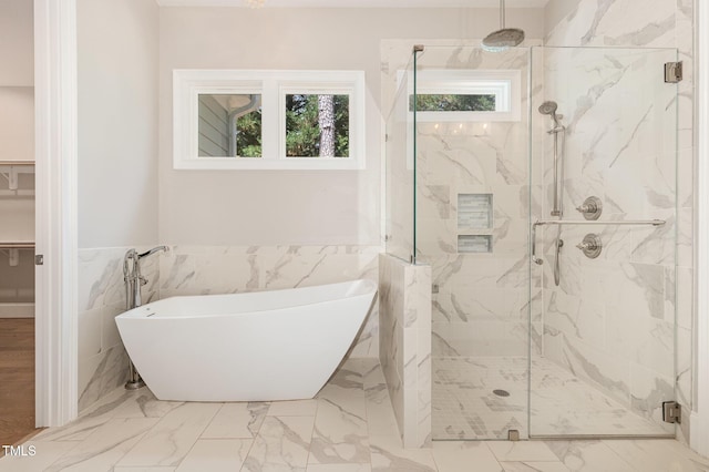 59 Cardinal Dr, Whispering Pines, NC 28327 - full bathroom featuring a marble finish shower, a soaking tub, marble look tiles, tile walls, and wainscoting
