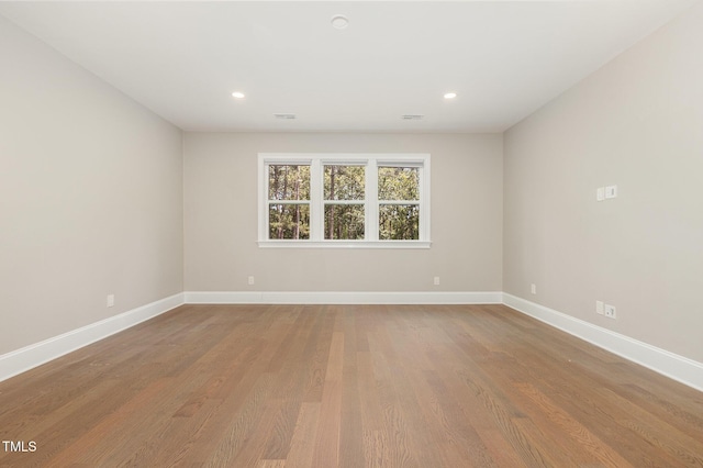 59 Cardinal Dr, Whispering Pines, NC 28327 - spare room featuring baseboards, wood finished floors, and recessed lighting