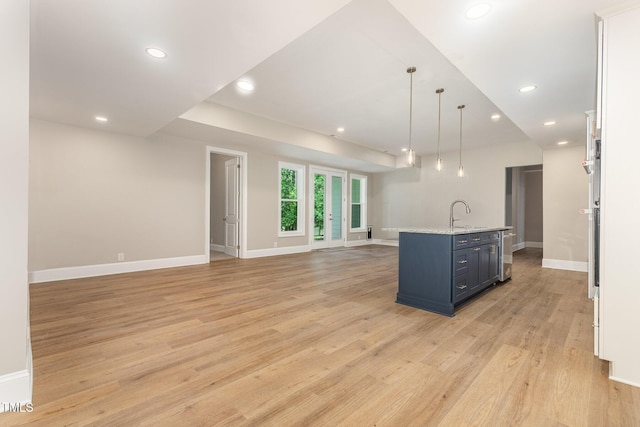 59 Cardinal Dr, Whispering Pines, NC 28327 - kitchen with light wood-style floors, baseboards, open floor plan, recessed lighting, and a center island with sink