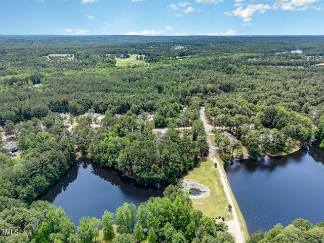 59 Cardinal Dr, Whispering Pines, NC 28327 - drone / aerial view of a heavily wooded area and a large body of water