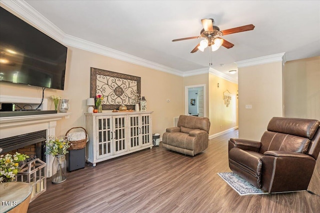 110 Lexington Ave, Zebulon, NC 27597 - living area with ornamental molding, ceiling fan, wood finished floors, baseboards, and a fireplace