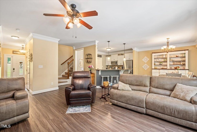 110 Lexington Ave, Zebulon, NC 27597 - living room featuring ceiling fan, ornamental molding, stairway, wood finished floors, and a chandelier