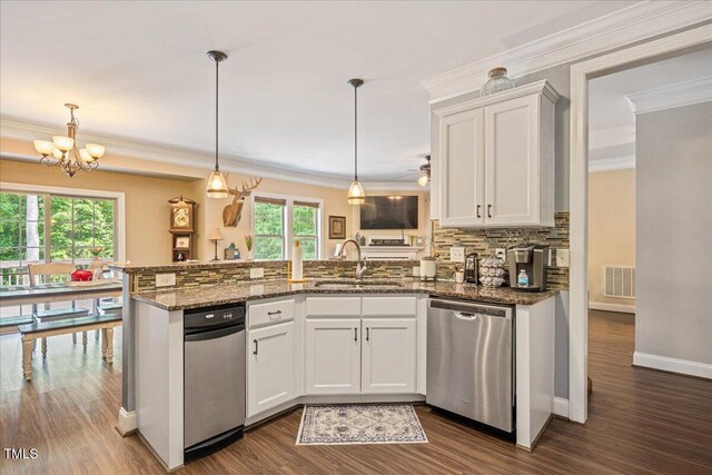 110 Lexington Ave, Zebulon, NC 27597 - kitchen with dishwasher, a sink, a peninsula, crown molding, and backsplash