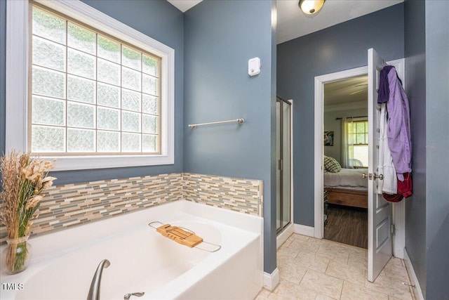 110 Lexington Ave, Zebulon, NC 27597 - ensuite bathroom with a garden tub, baseboards, and a shower stall