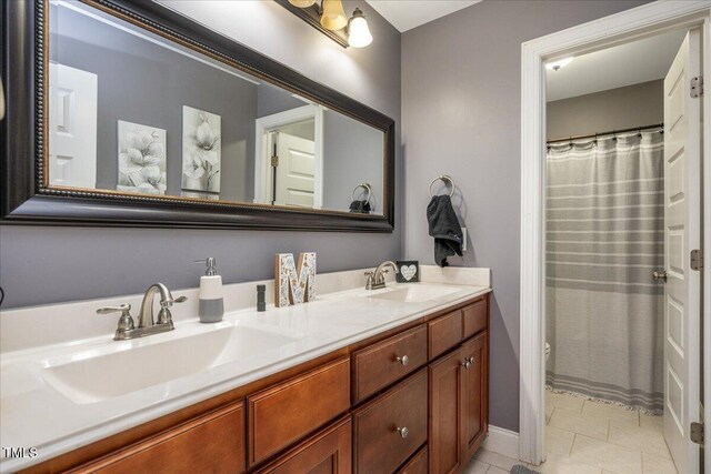 110 Lexington Ave, Zebulon, NC 27597 - full bath featuring double vanity, toilet, tile patterned flooring, and baseboards