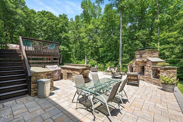 110 Lexington Ave, Zebulon, NC 27597 - view of patio / terrace with stairway, a deck, and an outdoor living space with a fireplace