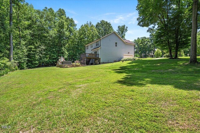 110 Lexington Ave, Zebulon, NC 27597 - view of grassy yard with a wooden deck