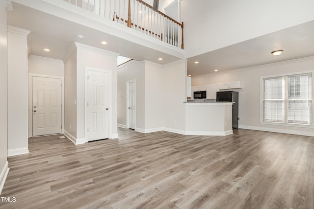 7936 Milltrace, Raleigh, NC 27615 - unfurnished living room with crown molding, baseboards, light wood-style flooring, a high ceiling, and recessed lighting
