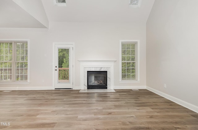 7936 Milltrace, Raleigh, NC 27615 - unfurnished living room with baseboards, healthy amount of natural light, a fireplace, and high vaulted ceiling