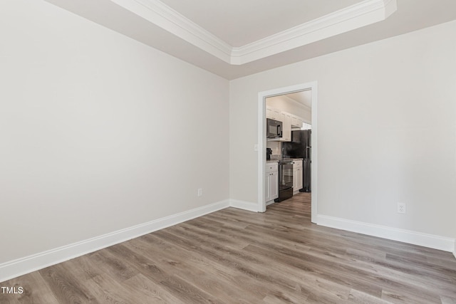 7936 Milltrace, Raleigh, NC 27615 - empty room with crown molding, light wood finished floors, a raised ceiling, and baseboards