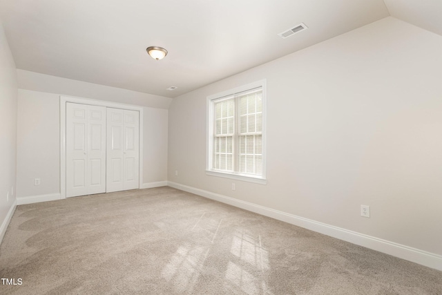 7936 Milltrace, Raleigh, NC 27615 - unfurnished bedroom featuring light carpet, baseboards, a closet, and lofted ceiling
