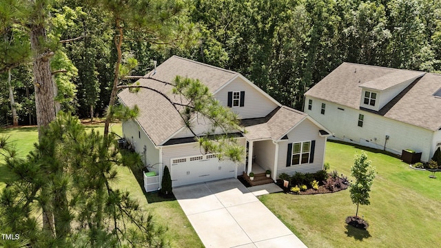 159 Clear Water Rd, Louisburg, NC 27549 - view of front of home with driveway, a front lawn, an attached garage, and a shingled roof