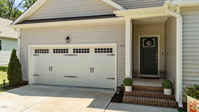 159 Clear Water Rd, Louisburg, NC 27549 - property entrance with driveway and an attached garage