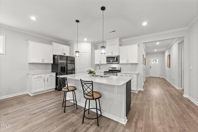 159 Clear Water Rd, Louisburg, NC 27549 - kitchen with stainless steel appliances, a sink, backsplash, light wood-style flooring, and light countertops