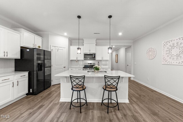 159 Clear Water Rd, Louisburg, NC 27549 - kitchen with appliances with stainless steel finishes, a sink, white cabinetry, decorative backsplash, and crown molding