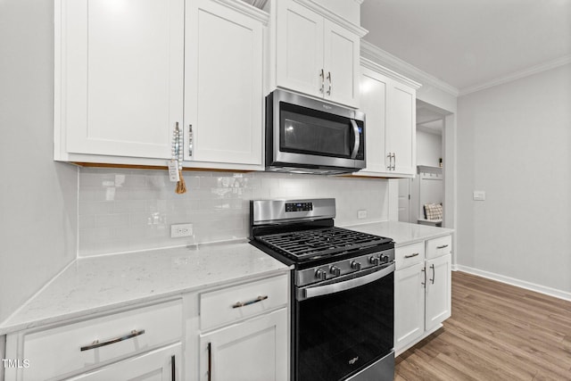 159 Clear Water Rd, Louisburg, NC 27549 - kitchen featuring stainless steel appliances, ornamental molding, decorative backsplash, baseboards, and white cabinets