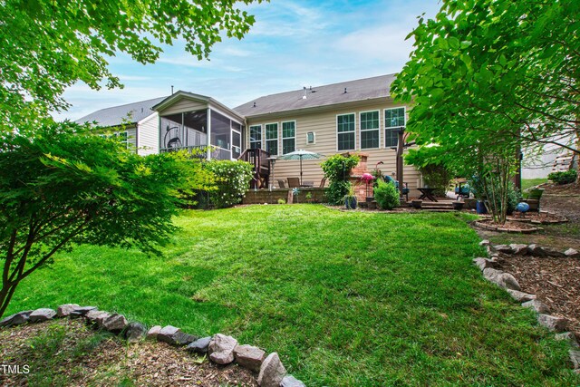 1577 Tice Hurst Ln, Apex, NC 27502 - rear view of property featuring a sunroom and a lawn